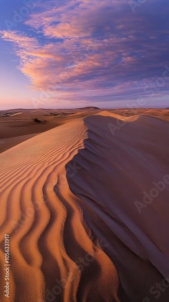 Obraz Sand dunes stretching under a colorful sunset sky in the desert