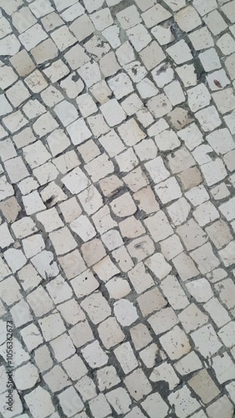 Fototapeta Calçamento com pedras formando textura abstrata.