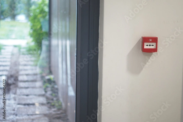 Fototapeta Red fire alarm button on wall ,
