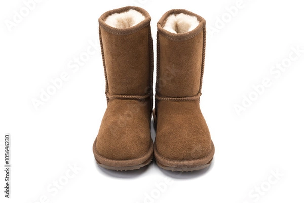 Obraz brown fluffy ugg boot style childrens footwear on white backgrou
