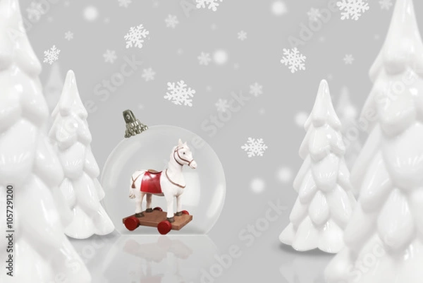 Obraz Christmas and New Year card with transparent ball, retro toy horse, trees, snowflakes, in white and gray colors