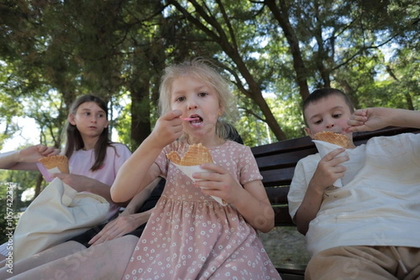Fototapeta Mother and three children having fun in the park