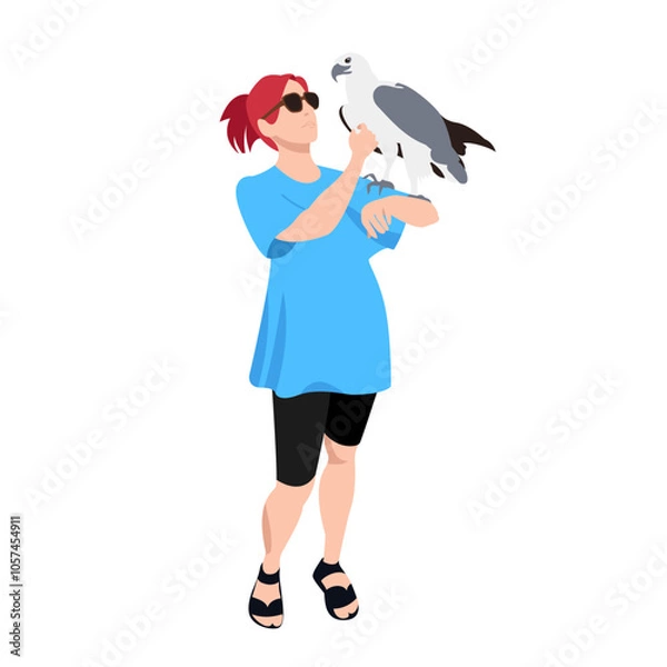 Obraz A woman and a bird. An eagle in the hands of a man. A bird of prey. A girl in casual clothes. Ornithologist