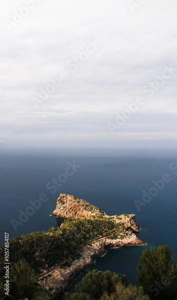 Fototapeta wide view of Cova de Sa Foradada, hole in a rock cliff on island mallorca
