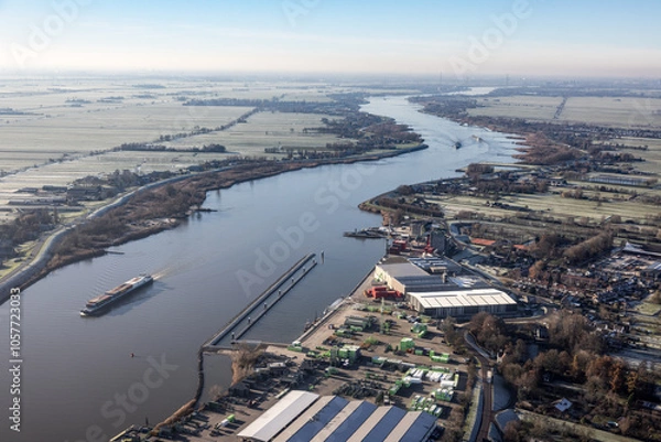 Fototapeta Aerial view Dutch river Lek with view at village Bergambacht