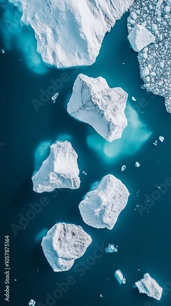 Fototapeta Icebergs floating in the ocean: an aerial view of glacial melt