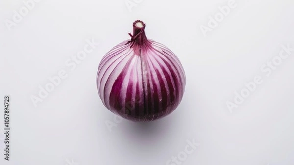 Fototapeta The red onion is placed alone on a pure white background