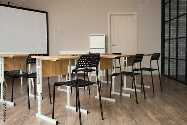 Fototapeta Interior of classroom with school desks and projector screen