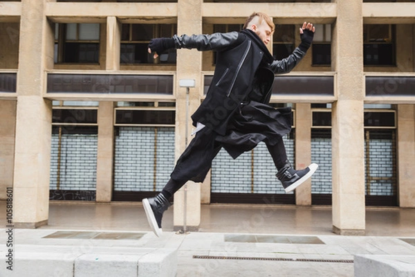 Obraz Stylish bearded man jumping in the street