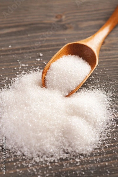 Fototapeta Sugar with spoon on a wooden table