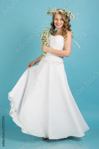 Obraz Bride with wreath of flowers isolated on blue