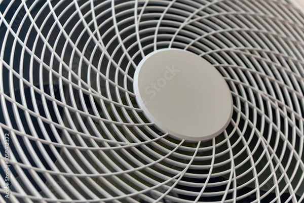 Obraz Close up of a metal fan grille with a circular pattern, showing intricate grid lines and symmetry, found in air conditioning or ventilation systems. Circular texture, symmetry ventilation systems