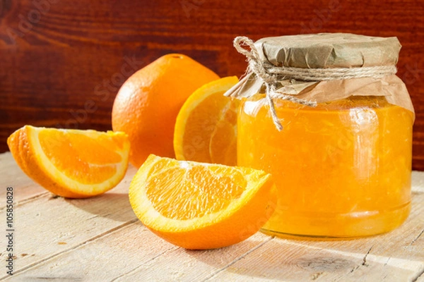 Obraz Банк апельсинового джема и несколько долек апельсина