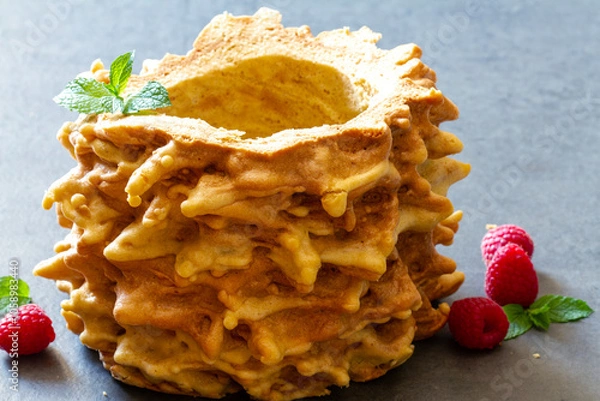 Obraz Lithuanian sakotis or Polish sękacz, traditional tree cake decorated with raspberries and mint