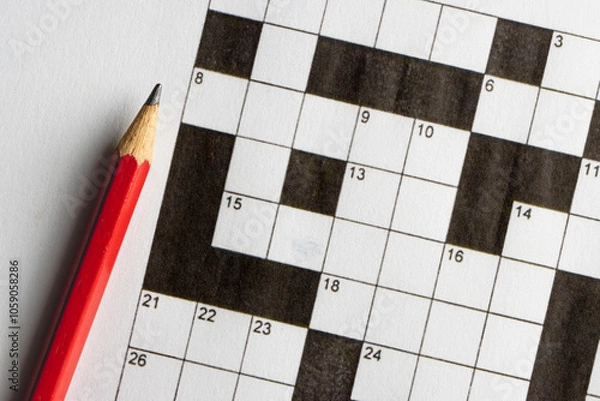 Obraz Empty, unfinished crossword puzzle, black and white crossword puzzle with a red pencil. On black background. 
