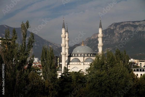 Fototapeta namazgah mosque in tirana, albania, framed with trees and sky