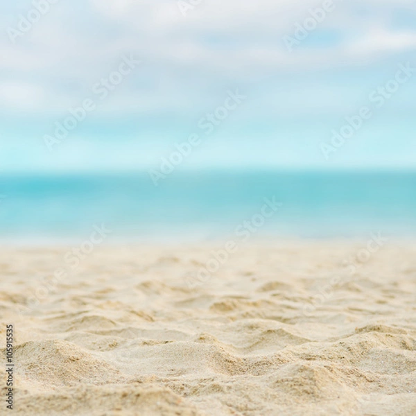 Fototapeta Close up sand with blurred sea sky background, summer day, copy space or for product.
