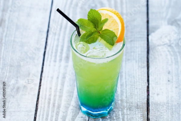 Fototapeta blue green cocktail with orange and mint