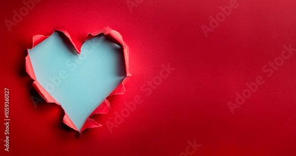 Fototapeta Ripped paper hole heart shaped on red paper background. Valentine`s day celebration concept.