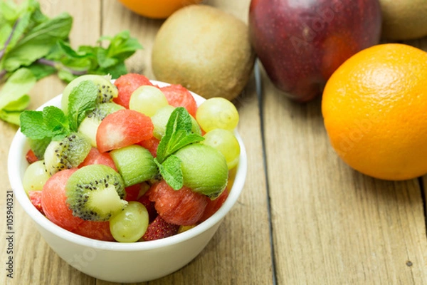 Fototapeta fruit salad with strawberries, oranges, kiwi, grape and watermel