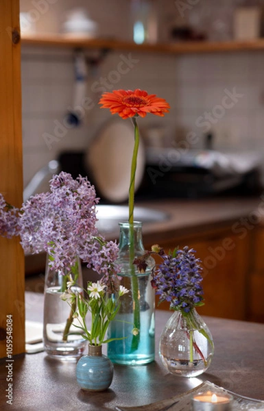 Obraz Vibrant Gerbera, Lilac, Lesser Stitchwort & Bugleweed in Glass and Ceramic Vases – Elegant Spring Floral Display
