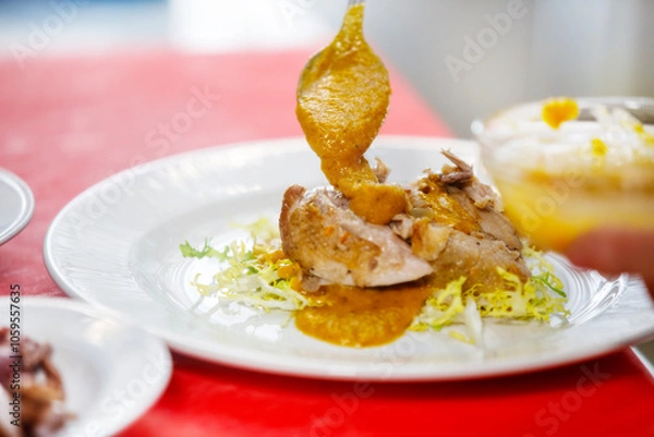 Fototapeta Chef is placing some sauce over quail in a salad