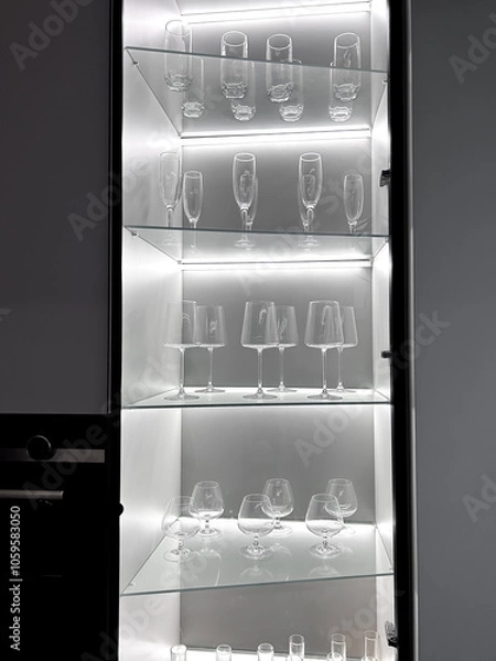 Fototapeta Glass cabinet with different glasses and glasses, all illuminated by a built-in panel