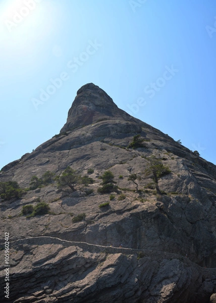 Fototapeta A tall, sharp mountain against the sky.