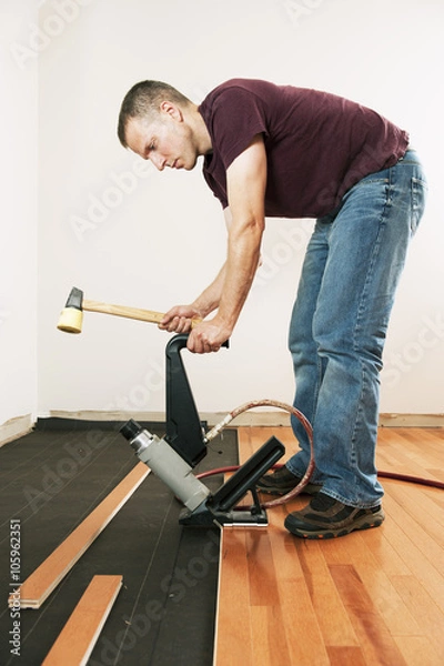 Obraz Man installing hardwood floor