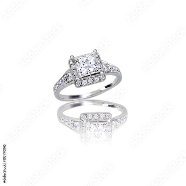Obraz Beautiful Diamond Wedding band princess cut halo setting engagement ring isolated on white with a reflection