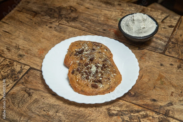 Fototapeta Chocolate chip cookie, Chocolate cookie with chocolate dips and ice cream flavor of vanilla, Chocolate cookie placed in a wooden dining table