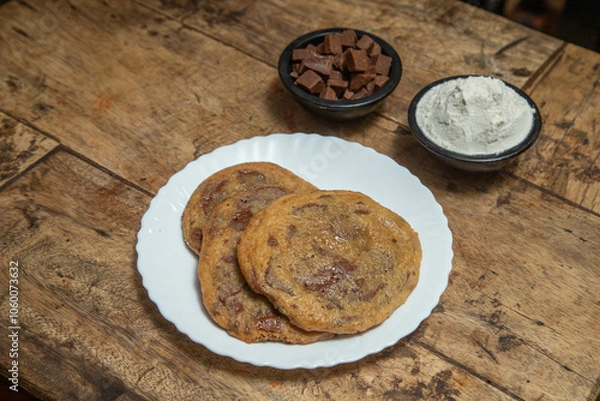 Fototapeta Chocolate chip cookie, Chocolate cookie with chocolate cubes and ice cream flavor of vanilla, Chocolate cookie placed in a wooden dining table