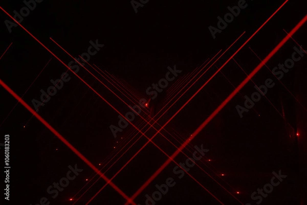 Obraz Red lasers in a dark room.