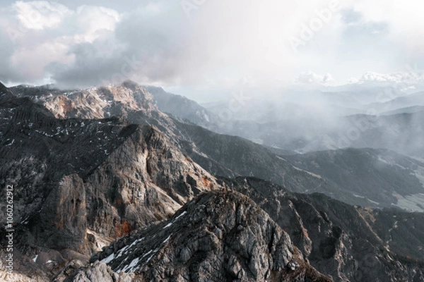 Obraz Breathtaking sunrise over foggy mountain landscapes, casting warm light through misty valleys. A serene and majestic scene, perfect for outdoor, nature, and adventure themes capturing dawn's beauty.
