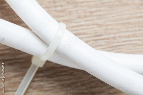 Obraz Bundles of network cables with cable ties on wooden table