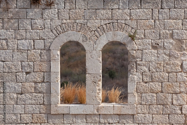 Fototapeta Window in an old wall. Window in an old wall. Remains of a fortress Migdal Tsedek, combining buildings from the Crusader and Ottoman periods