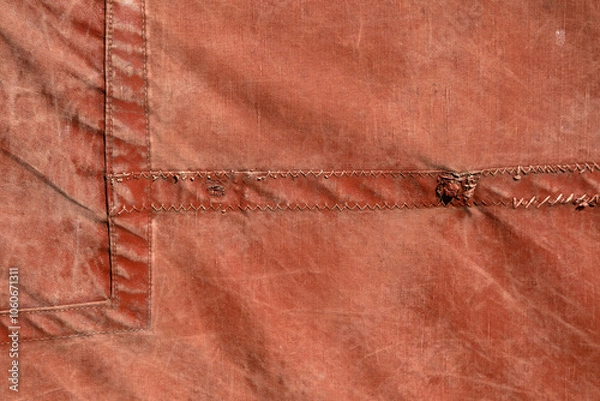 Fototapeta Closeup of old red canvas sail as used on Thames Barges for use as a background texture