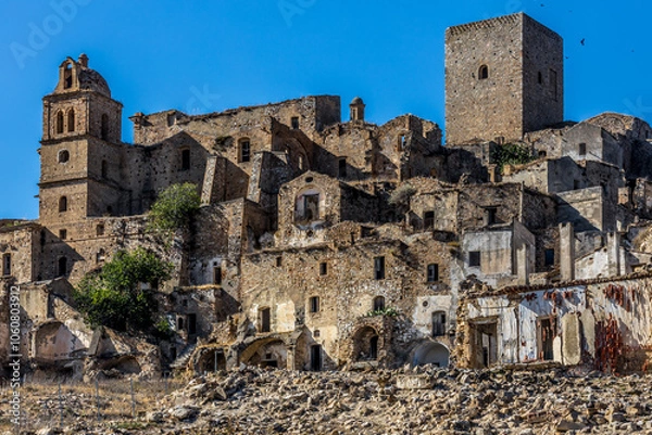 Fototapeta Abandoned ruins of the ghost town of Craco. A city abandoned due to an earthquake in the late 20th century. Province of Matera, Basilicata, Italy