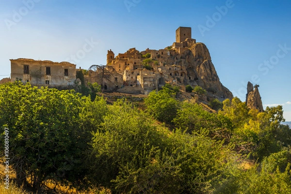 Fototapeta A picturesque view of the abandoned, old mountain town of Craco, built of sandstone rock. Craco is a ghost town abandoned due to an earthquake in the late 20th century. Province of Matera, Basilicata,