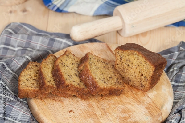 Obraz Homemade banana bread sliced on a table . rustic style