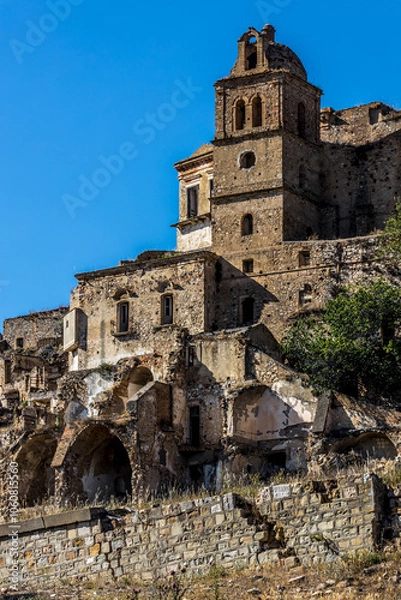 Fototapeta Abandoned ruins of the ghost town of Craco. A city abandoned due to an earthquake in the late 20th century. Province of Matera, Basilicata, Italy
