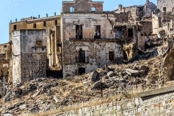 Fototapeta Abandoned ruins of the ghost town of Craco. A city abandoned due to an earthquake in the late 20th century. Province of Matera, Basilicata, Italy