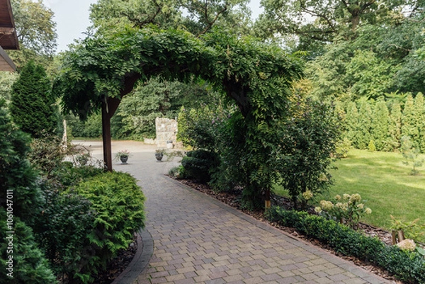 Fototapeta Beautiful summer garden with a walkway winding its way through