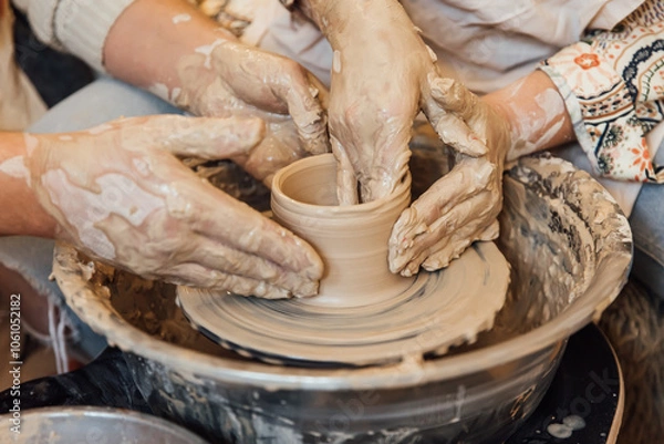 Fototapeta Cropped shot of unrecognizable child making ceramic mug at pottery class