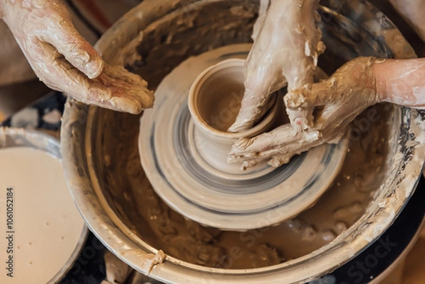 Fototapeta Cropped shot of unrecognizable child making ceramic mug at pottery class