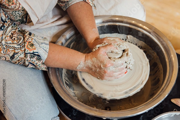 Fototapeta Cropped shot of unrecognizable child making ceramic mug at pottery class