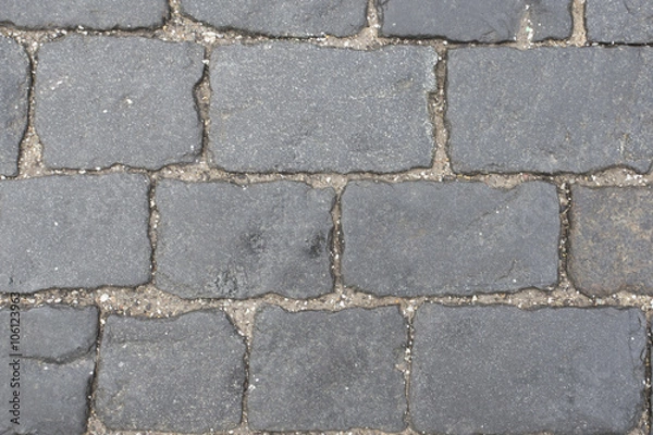 Fototapeta Stone blocks in the walkway,patterned paving tiles. Grey stone texture
