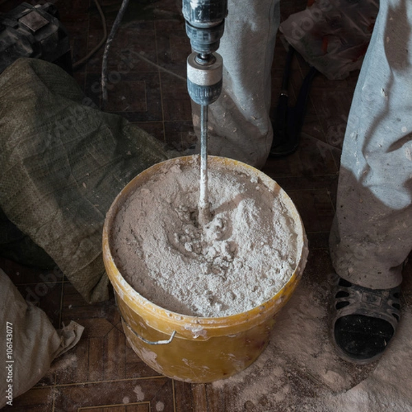 Fototapeta Stirring mortar using drills