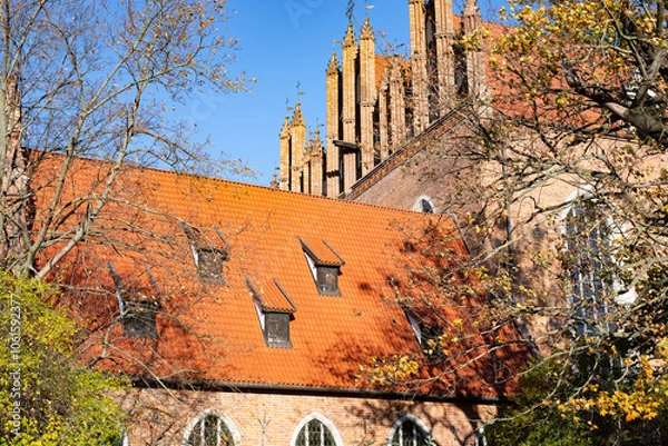 Fototapeta A beautiful red brick Gothic building. Ancient architecture.
