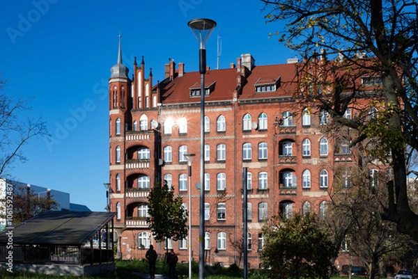 Fototapeta A beautiful red brick Gothic building. Ancient architecture. Living space.